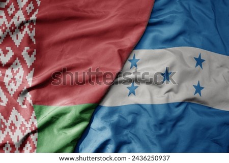 big waving national colorful flag of honduras and national flag of belarus. macro