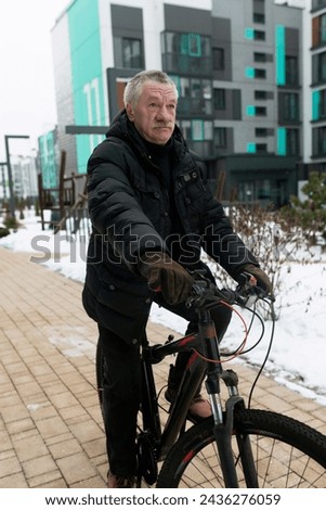 European elderly man rents a bicycle to ride around the city
