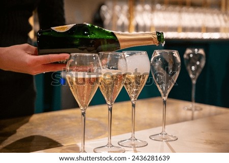 Pouring and tasting of dry sparkling wine champagne on winter weekend festival in December on Avenue de Champagne, Epernay, Champagne region, France Royalty-Free Stock Photo #2436281639