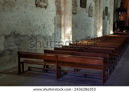 Views of interior of old church of medieval town St. Emilion, production of red Bordeaux wine on cru class vineyards in Saint-Emilion wine making region, France, Bordeaux in sunlights Royalty-Free Stock Photo #2436286353