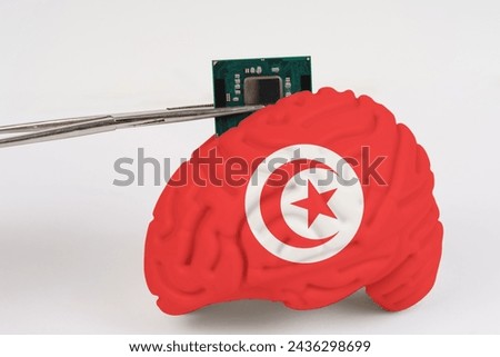 On a white background, a model of the brain with a picture of a flag - Tunisia, a microcircuit, a processor, is implanted into it. Close-up