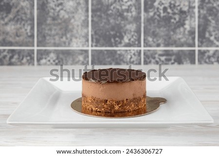Chocolate mousse cake. Sweet and tasty chocolate cake great for during coffee break. Freshly made delicious chocolate cake on wooden table. Space for text.