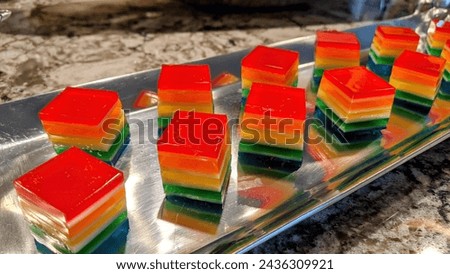 Rainbow Layered Jelly Desserts on Metallic Tray in Kitchen