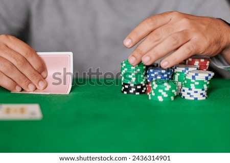 Closeup of hand betting chips in casino