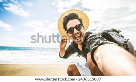 Happy young man taking selfie at the beach side - Smiling guy looking at camera outside - Summer vacations and technology concept 