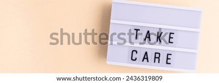 Take care. Banner with white lightbox with letters on a beige background. Place for text.