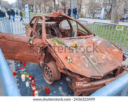 burned-out civilian car. War in Ukraine. Russian invasion of Ukraine. War crimes Royalty-Free Stock Photo #2436323499