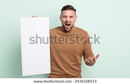 young handsome man looking angry, annoyed and frustrated. empty canvas concept