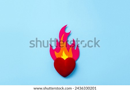 Flame cut out of cardboard and decorative heart. Postcard for Valentine's Day. Selective focus, copy space