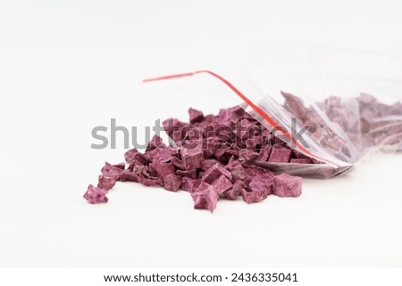 Multiple dried purple sweet potatoes on white background