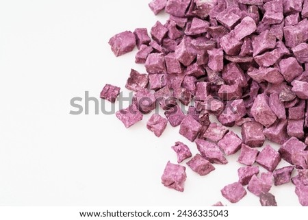 Multiple dried purple sweet potatoes on white background