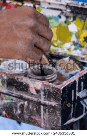 street painter with brush and paint, Asilah, morocco, africa Royalty-Free Stock Photo #2436336501