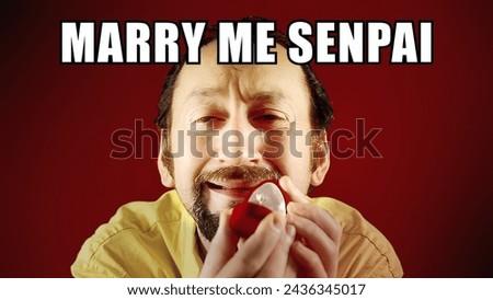 Reaction meme (internet pop culture): an ecstatic ugly man kneeling in front of her girlfriend, showing an engagement ring, with the caption Marry me senpai (Master in Japanese).
 Royalty-Free Stock Photo #2436345017