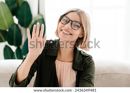 Closeup photo of caucasian young freelancer in formal clothes wearing glasses looking at camera on videocall. Online webinar with customers, e-learning, remote studies at home Royalty-Free Stock Photo #2436349481