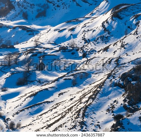 Winter landscape covered in snow in Guarguero waterfalls around port of Estacas de Trueba. Aerial view with drone. Espinosa de los Monteros. Pasiegos Valleys. Burgos. Castile and Leon. Spain. Europe