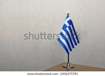 Greece table flag on gray blurred background