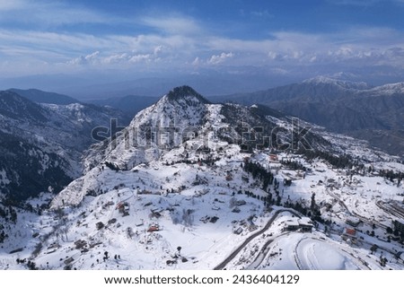 Aerial View of Malam Jabba Hill station in winter, Mountains and pine trees covered in snow