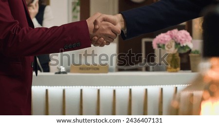 Business partners shake hands on collab, obtaining accord to implement new ideas after global shareholder meeting. Executive managers in agreement to start collaboration. Close up. Handheld shot. Royalty-Free Stock Photo #2436407131