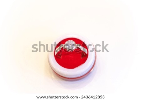 Picture of a ring kept in a box with a white background. Silver, golden, platinum, fashion, chain, jewelry, girl, women, indian, asian, price, fall, stock, market, symbol, love, gift, engagement.