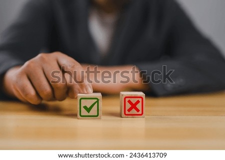 Businessman is thinking and making choices right from wrong symbols. Decide to vote accept or not. Yes or No decisions, business options in difficult situations. True False, crisis decision making. Royalty-Free Stock Photo #2436413709