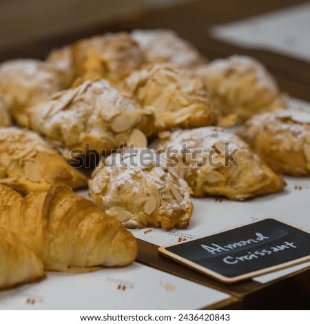 Good morning concept - Freshly baked croissants on a tray with a small jar of jam for breakfast