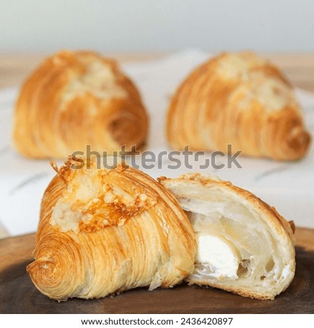 Good morning concept - Freshly baked croissants on a tray with a small jar of jam for breakfast