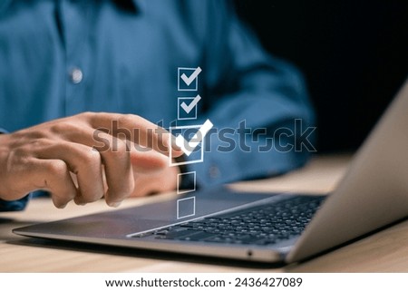 Checklist concept. Businessman using laptop to checking mark on checkboxes.