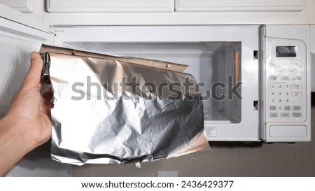 Demonstrating picture of the danger of a food foil in microwave can start a fire