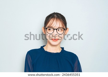 Asian woman wearing fashionable eyeglasses.