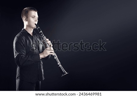 Clarinet player classical musician portrait. Clarinetist playing woodwind musical instrument