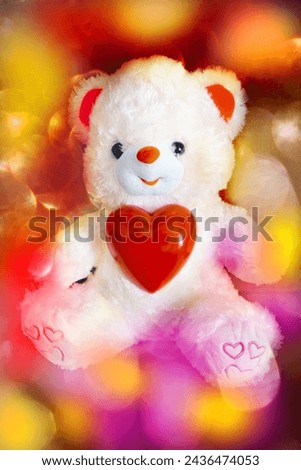 Toy bear with a heart. Glowing colorful lights.  Preparation for a romantic holiday. Valentines Day, Birthday, wedding