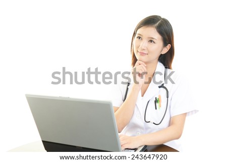 Medical doctor reviewing her notes on laptop