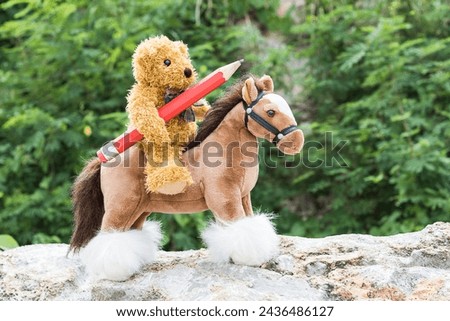 Teddy bear ride a horse and hold pencil in forest
