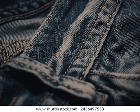 Dark jeans texture at night for a super cool fashion background.  Royalty-Free Stock Photo #2436497533