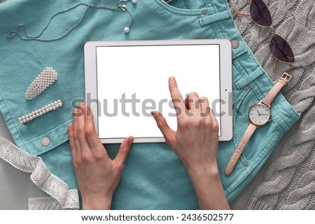 Woman with modern tablet at table, top view. Space for text