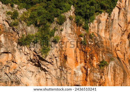 Limestone mountain cliff seen in Kin Loong Valley, Ipoh, Perak, Malaysia. Royalty-Free Stock Photo #2436510241