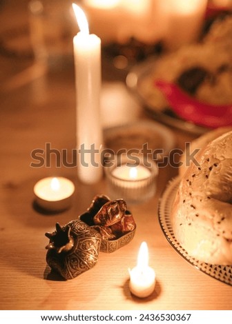 Dried date palm fruits or kurma, and candles on iftar table ramadan ( ramazan ) food concipt