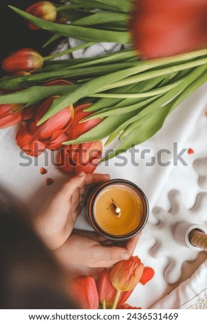 A girl holds a candle in her hands, spring mood.
