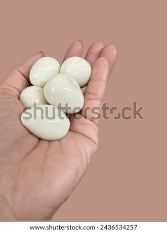Quail eggs boiled and then peeled for eating. placed on people's hands,use to Easter day,believed that if you ate eggs you'd have good life and will bring eggs to draw various picture together happily