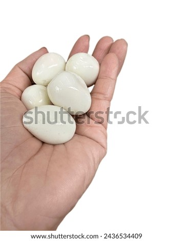 Quail eggs boiled and then peeled for eating. placed on people's hands,use to Easter day,believed that if you ate eggs you'd have good life and will bring eggs to draw various picture together happily