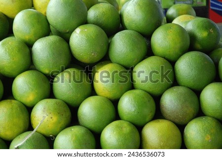 Piles of green oranges that are ripe and handpicked from the fields are ready to be bought and sold Royalty-Free Stock Photo #2436536073