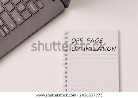 Black laptop and notebook have text Off-page Optimization on the white desk. Concept improve website visibility and rankings on search engines