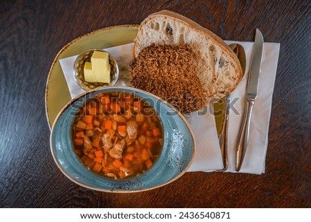 Traditional Icelandic lamb goulash, bread and butter, summer time, indoor, dining wooden table, Iceland