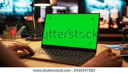 Anonymous Designer Working on a Laptop Computer with Mock Up Green Screen Chromakey Display with Isolated Placeholder. Video Template for Artistic Content Creation and Presentations