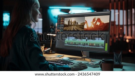 Portrait of Female Videographer Working on a Film on Her Desktop Computer. Focused Woman Making a Video Montage and Design for a Clip in Creative Office at Night
