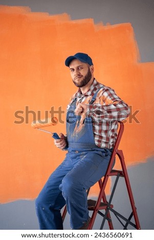 Dissatisfied painter sitting on the stairs showing a thumbs down gesture, bad job, disagrees. Copy space
