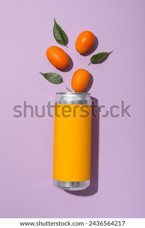 Tin can and kumquats on purple background, top view Royalty-Free Stock Photo #2436564217