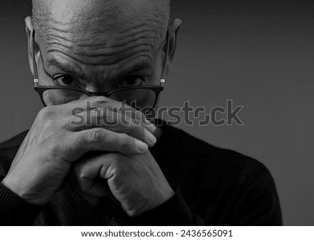 black man praying to god with hands together Caribbean man praying on black background with people stock photos stock photo