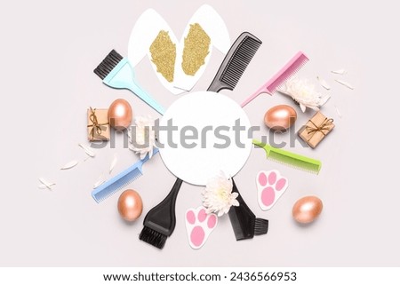 Composition with blank card, hairdresser's supplies and Easter decor on light background
