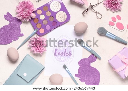 Composition with greeting card, makeup accessories, cosmetics and Easter decor on light background